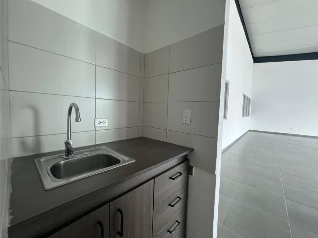 Small minimalist bathroom toilet pedestal sink tiled walls industrial warehouse Panama