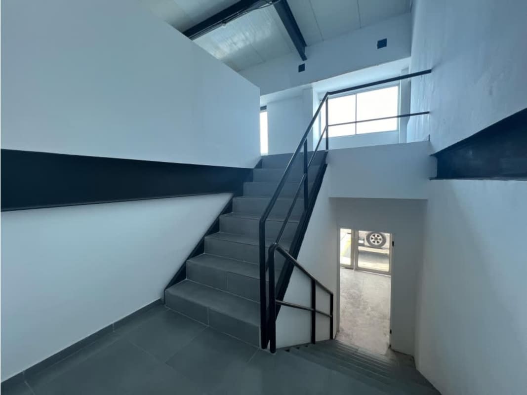 Minimalist kitchenette with sink backsplash and cabinets inside warehouse Panama