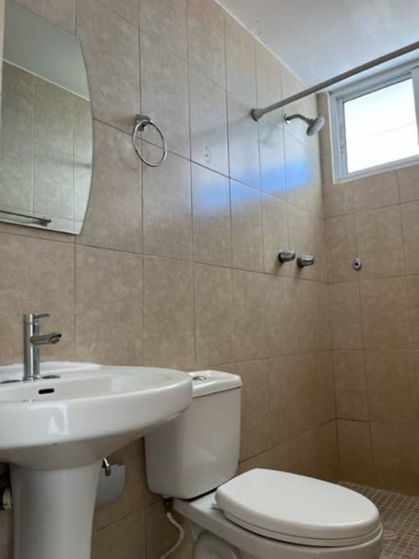 Contemporary bathroom with beige tiles pedestal sink walk-in shower PH Altavista Panama