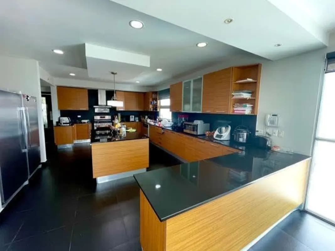 Master bedroom with large windows and ensuite bathroom at PH Altos del Golf Panama