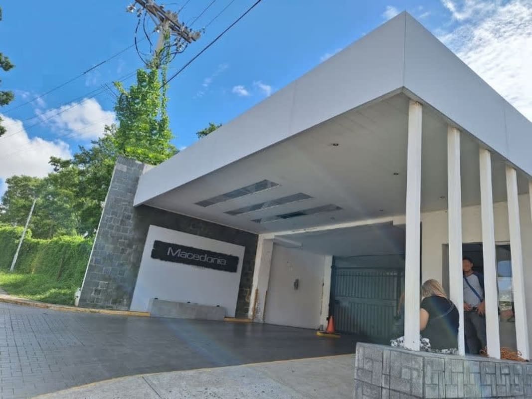Modern lobby with seating, large windows and security PH Macedonia Towers