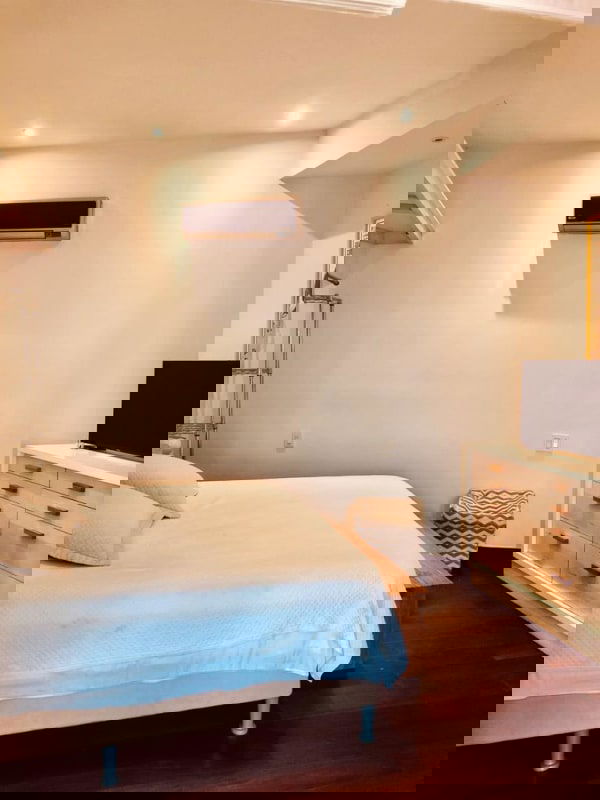 Bright bedroom with wood floors, closet and minimalist design in Casa Jeronimo Casco Viejo