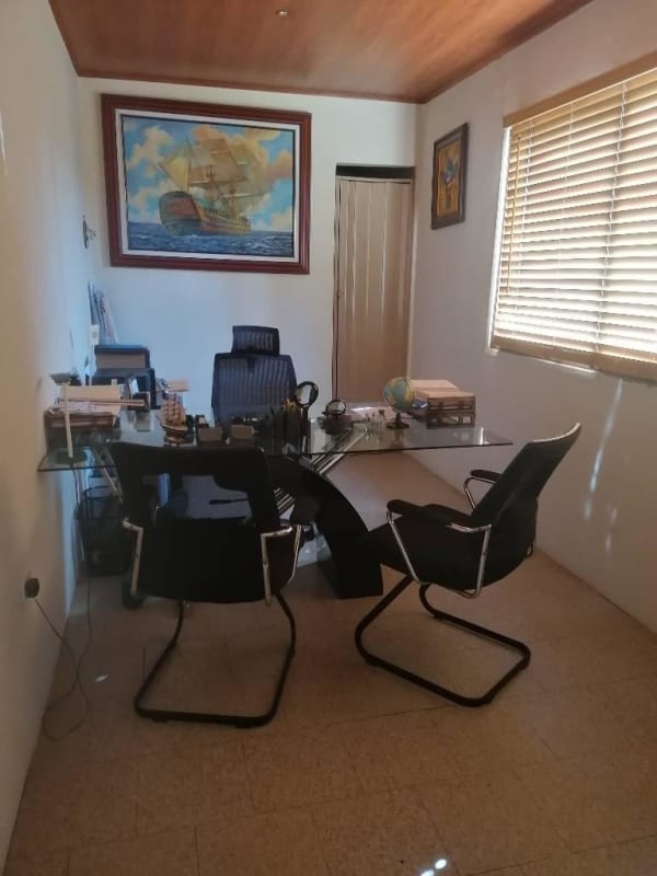 Contemporary office interior with glass desk chairs at Calzada Larga commercial facility Panama