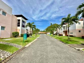 Two-story villa balcony with white railings overlooking tropical landscape Villas de Camarón Rio Hato Panama