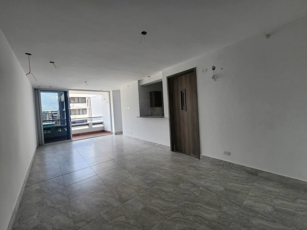 Kitchen with marble-style tiles and wooden cabinetry PH Luxor Tower El Cangrejo
