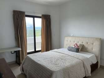 Modern bathroom with dark wood double sink vanity, corner soaking tub at Vista Mar condominium Panama