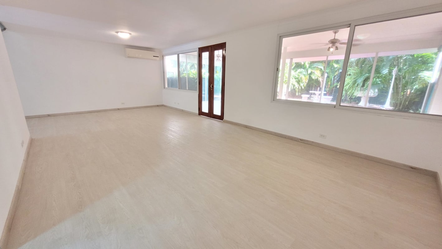 Bright living room with wood floors, garden views, glass doors in Punta Paitilla house