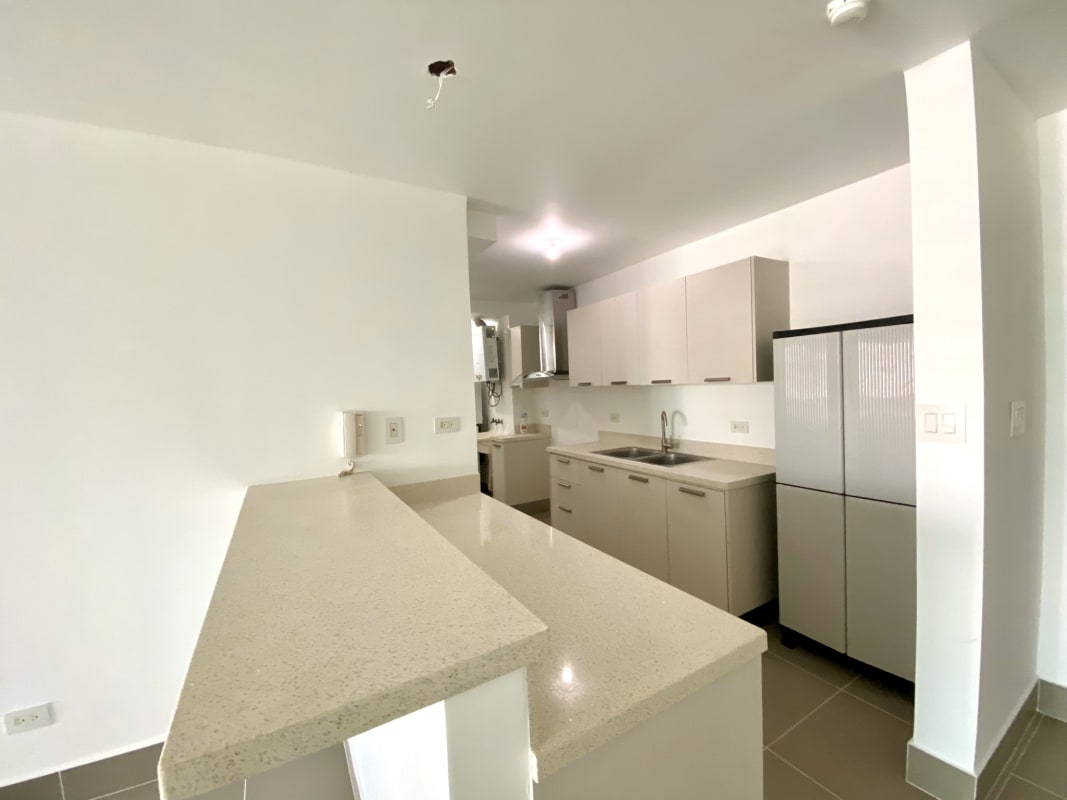 Galley kitchen in PH Miramar Panama with granite countertops and modern cabinetry
