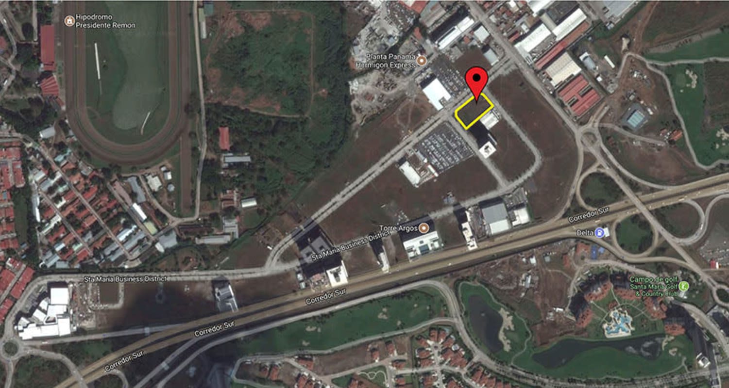 Aerial view of Santa María Business District showing corporate buildings, golf course, highway, and outlined commercial lot for sale