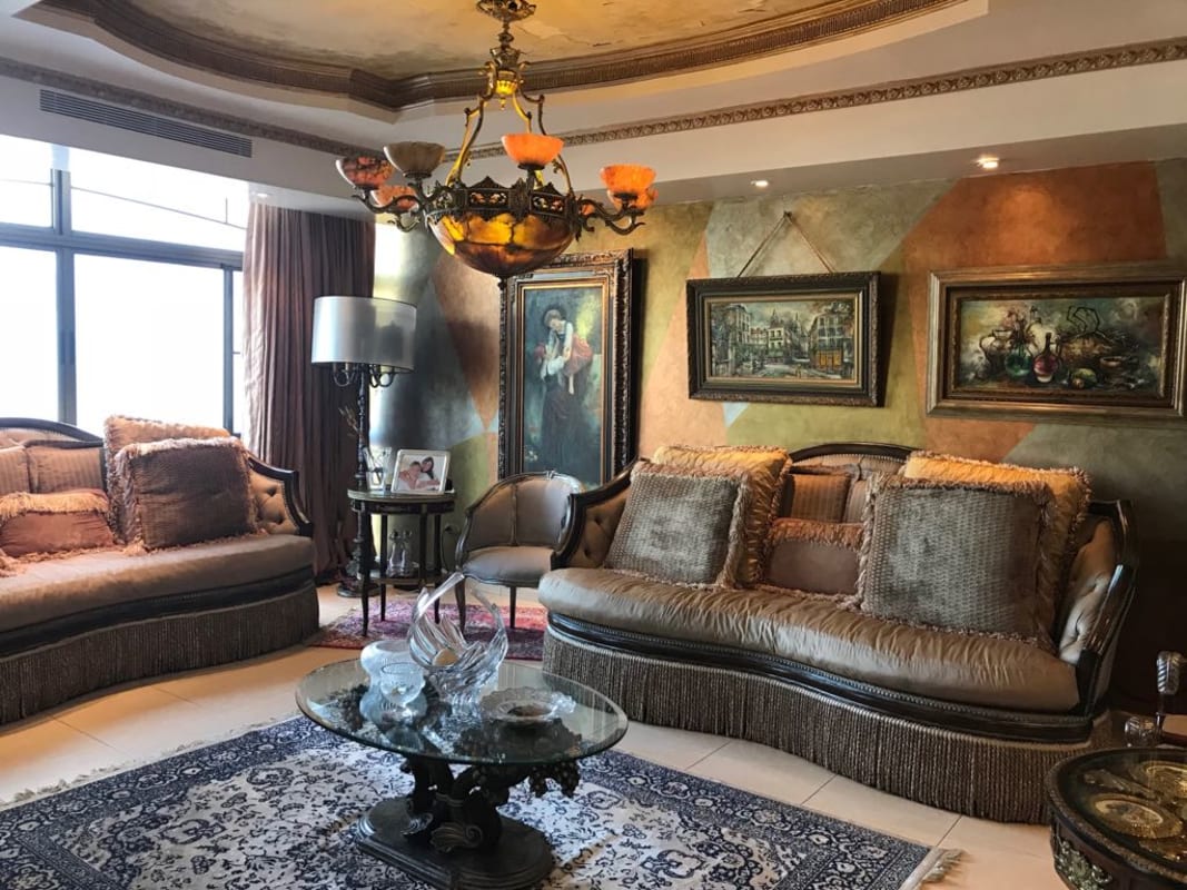 Traditional dining room with chandelier and large windows in Dos Mares residence Panama