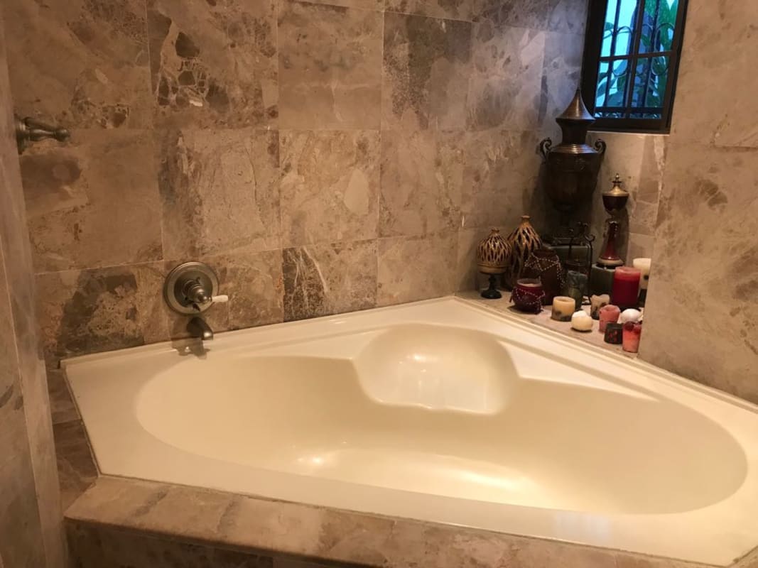 Mediterranean-style bathroom with stone tile and bathtub in Dos Mares villa Panama