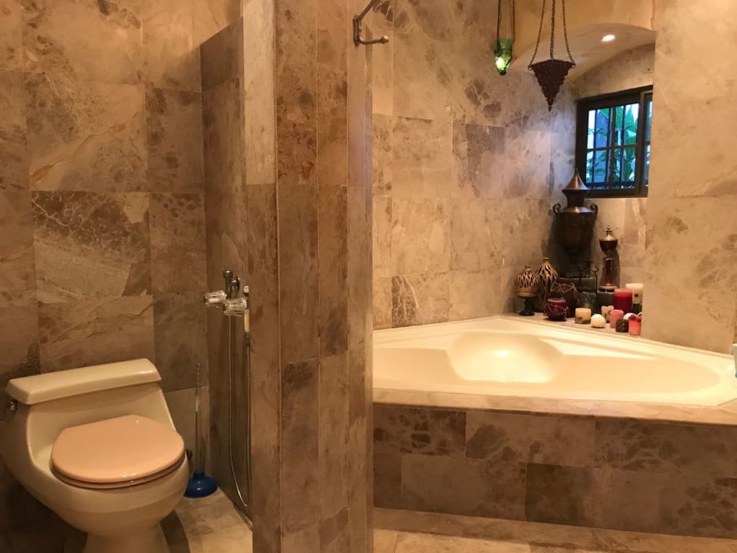 Classic staircase with wrought iron railings brick accent wall Dos Mares Panama