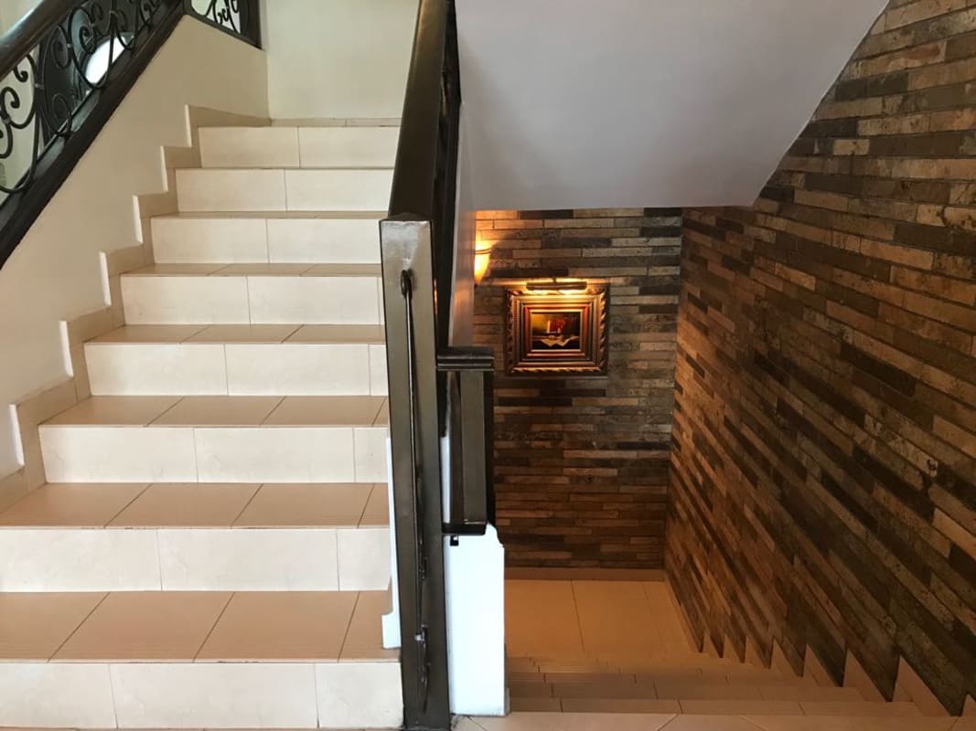 Luxury bathroom with built-in marble corner bathtub and candles Dos Mares villa Panama