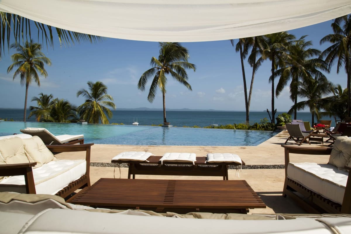 Spacious dining area with floor-to-ceiling windows showcasing ocean view La Península Panama