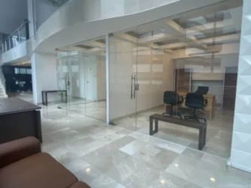 Furnished executive office with modern glass walls and marble flooring Grand Plaza Panama City