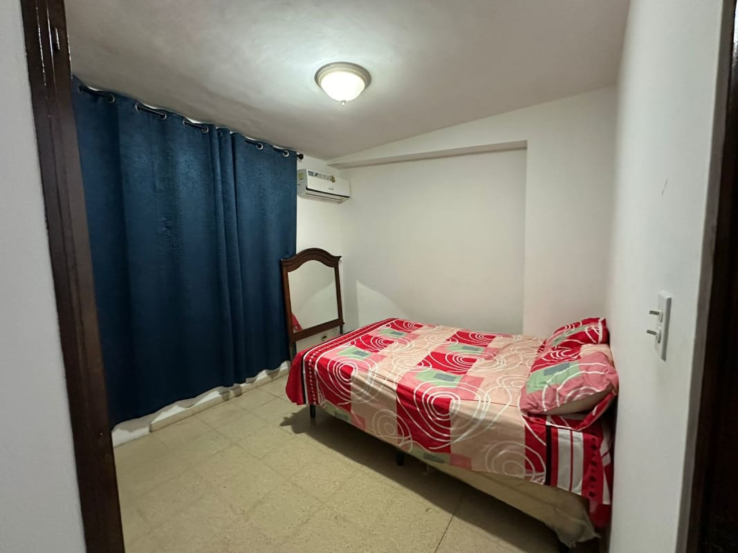 Small bedroom with split AC curtains tiled floors PH Plaza del Golf Panama