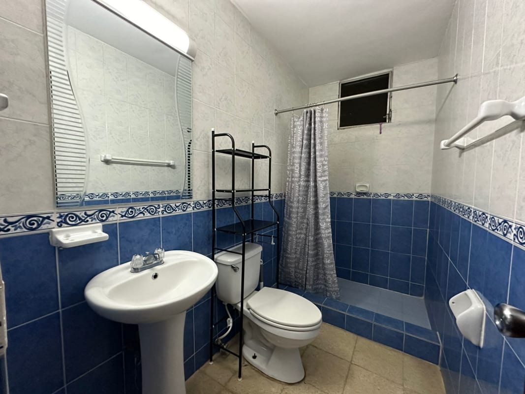 Bathroom with blue white tiles walk-in shower pedestal sink PH Plaza del Golf Panama