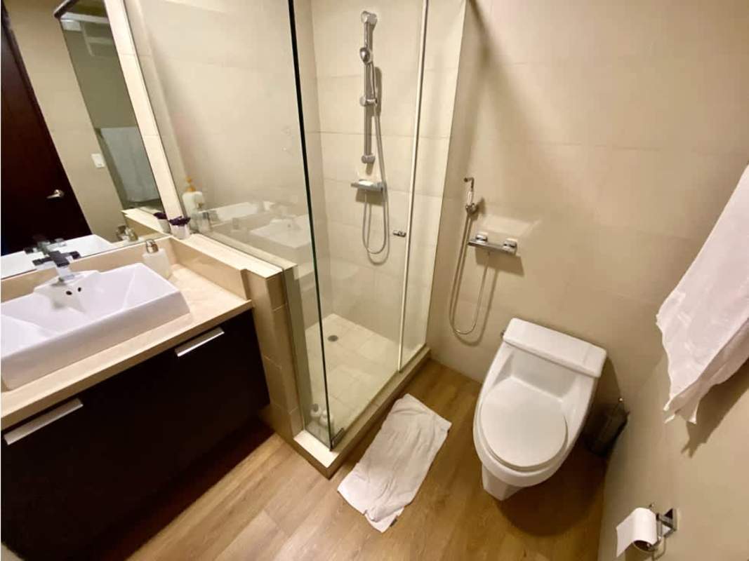 Bedroom with large windows overlooking city and ocean at PH Oceanaire Punta Pacifica