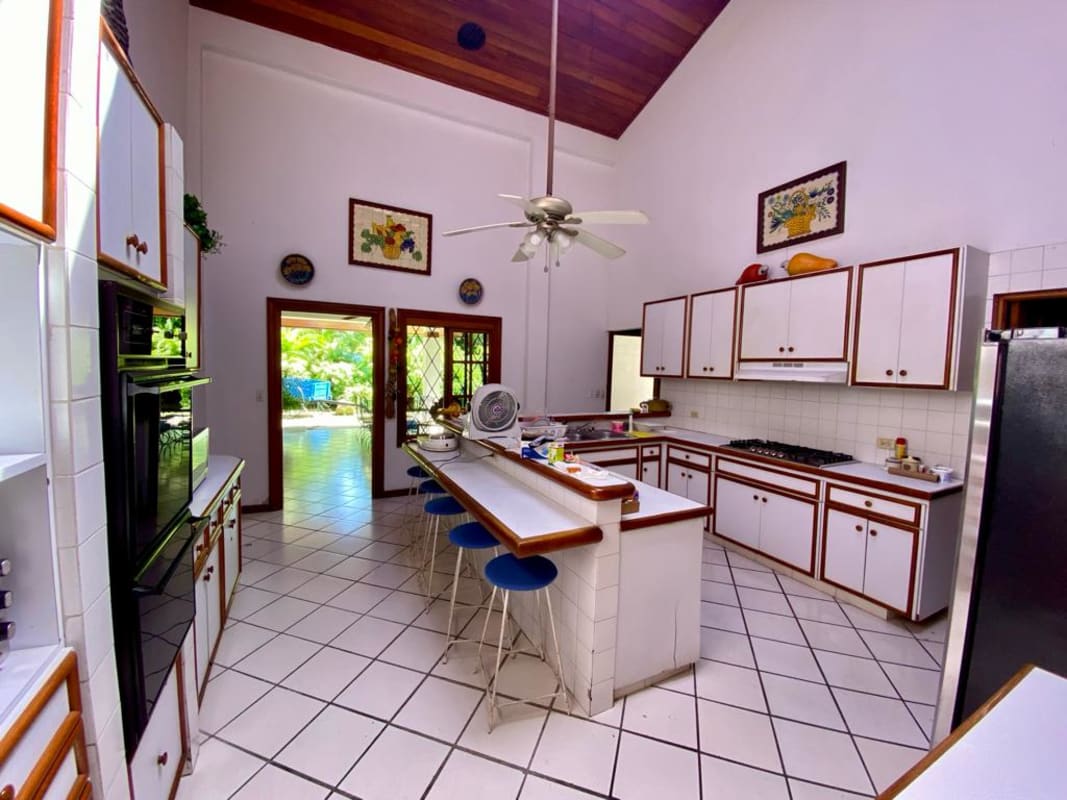 Living and dining room under vaulted ceiling with skylight in luxury Panama home