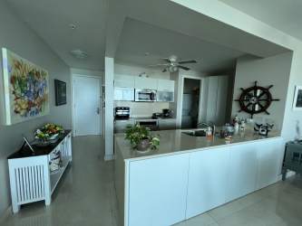 Modern living space with floor-to-ceiling windows facing ocean at PH Casa Bonita