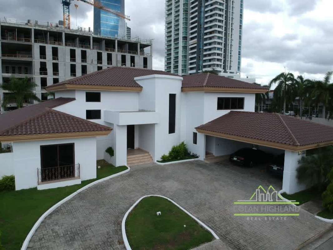 Gated luxury house exterior with tiled roof, large driveway, in Costa del Este for rent Panama City