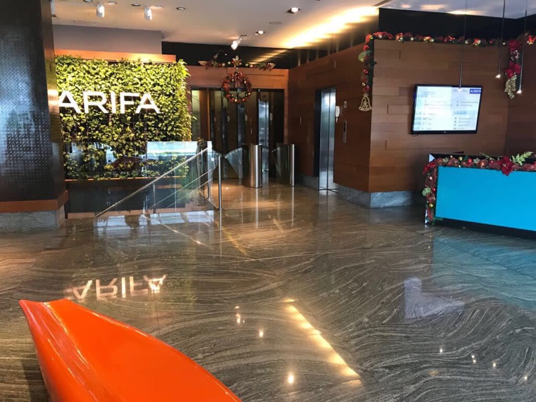 Elegant lobby marble floors green wall reception elevators Santa Maria Business District Tower Panama