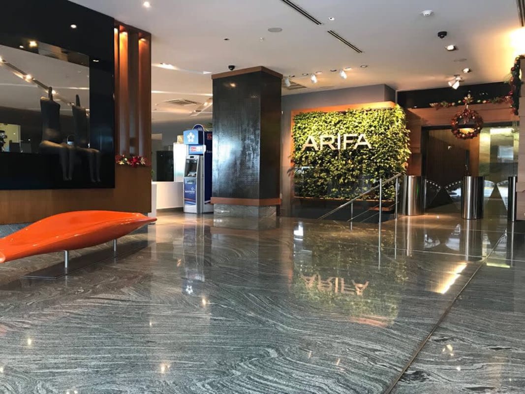 Marble lobby with vertical garden and access control turnstiles in Santa Maria Business District Tower Panama