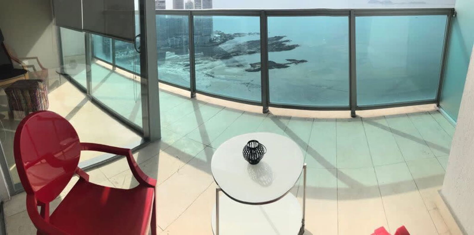 Spacious balcony with glass railing and ocean views at PH Arts & Yoo Avenida Balboa Panama