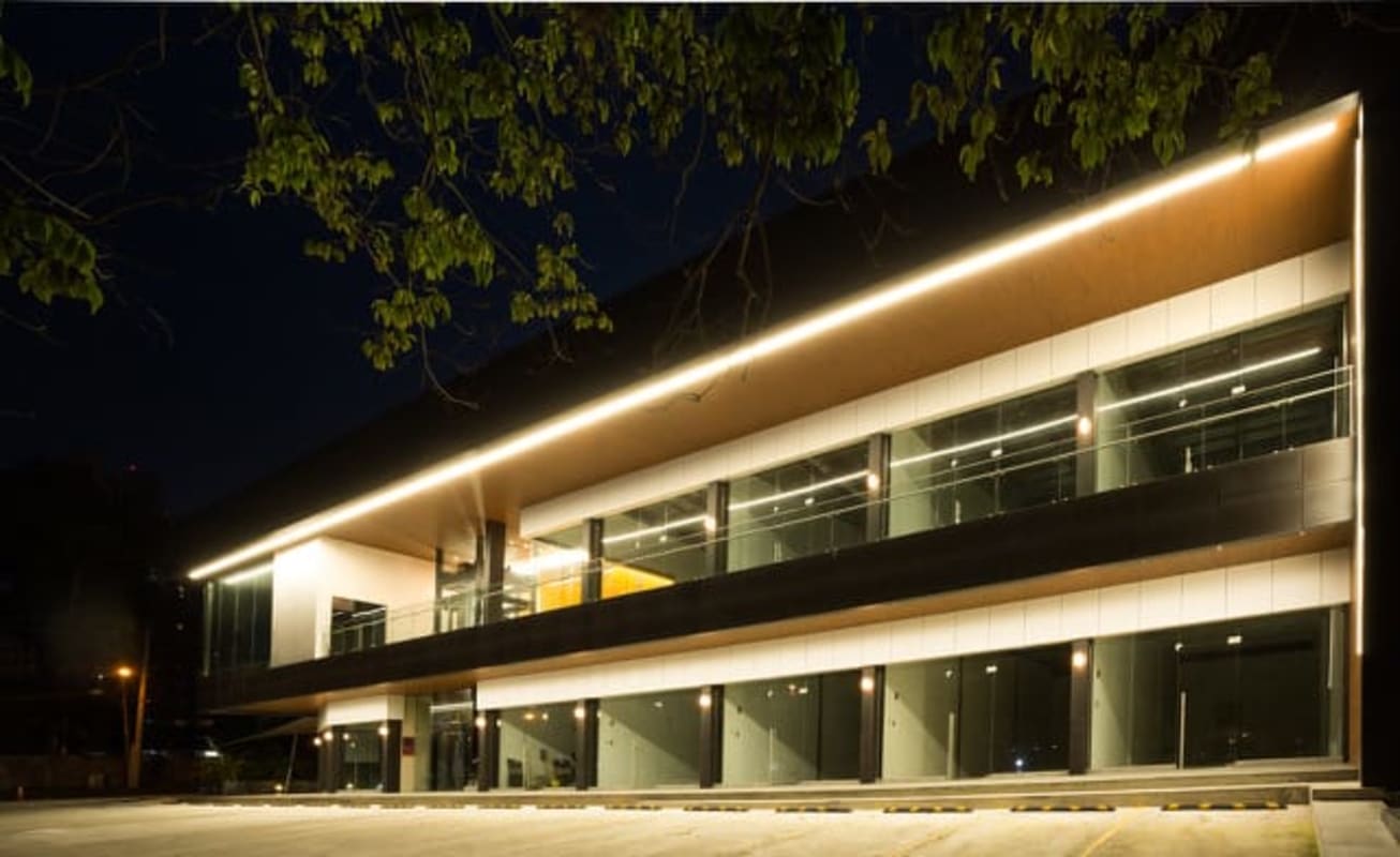 Modern commercial building with glass facade and LED lighting at night Panama City Plaza Santa Elena