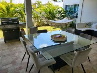 Large covered terrace patio with ceiling fan, seating area in PH Ibiza Beach Residences Panama