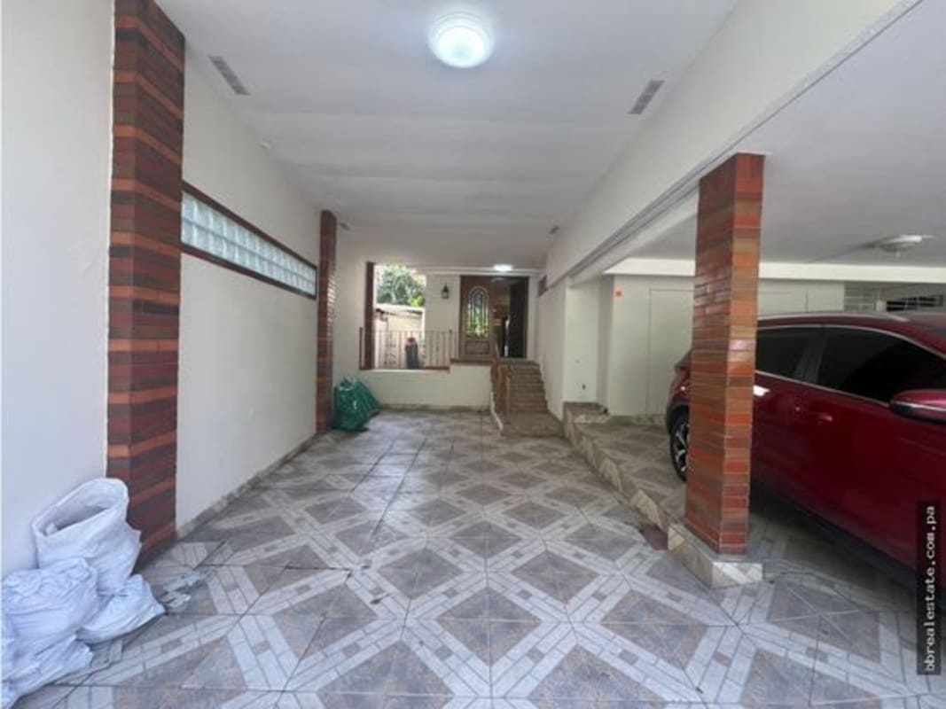 Covered tiled garage area with brick columns, secure parking for multiple cars in Punta Paitilla Panama City home