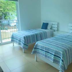 Private tennis court with garden landscaping in Punta Barco Village Panama