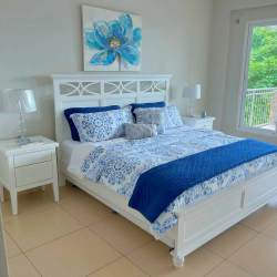 Bright bedroom with large garden view windows in Punta Barco Village Panama