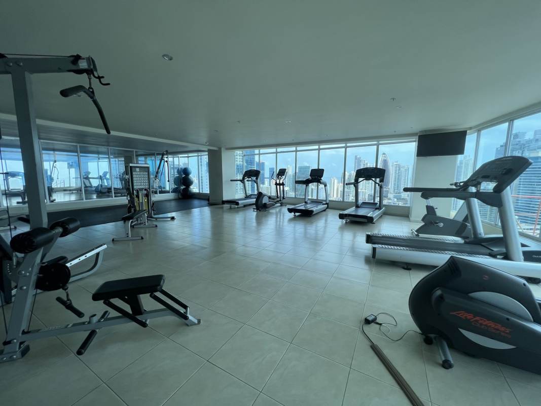 Modern gym with panoramic city views and fitness equipment at PH Grand Bay Avenida Balboa Panama