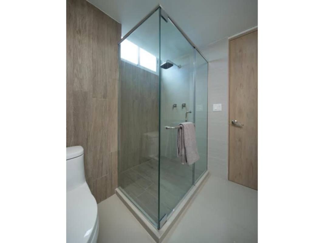 Spacious master bedroom with full height windows and skyline view in El Cangrejo Panama City