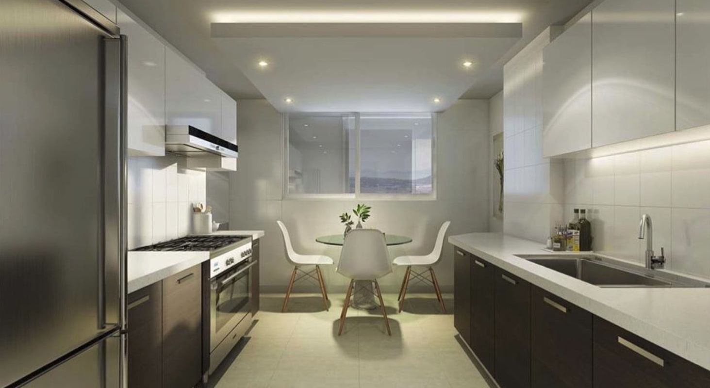 Compact kitchen with white cabinets, stainless appliances, dining table in Forest Gate Residences Clayton Panama City