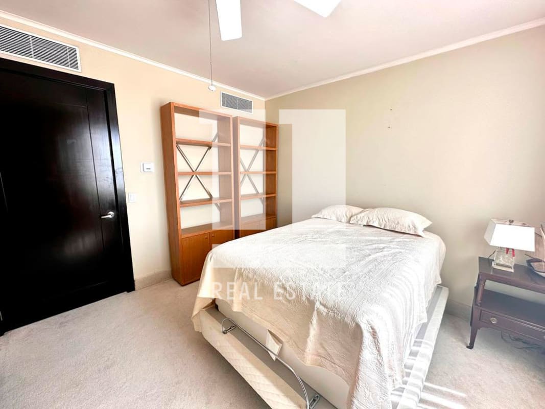 Luxury bedroom with large windows, city skyline view, walk-in closet in PH Park One Altos del Golf Panama