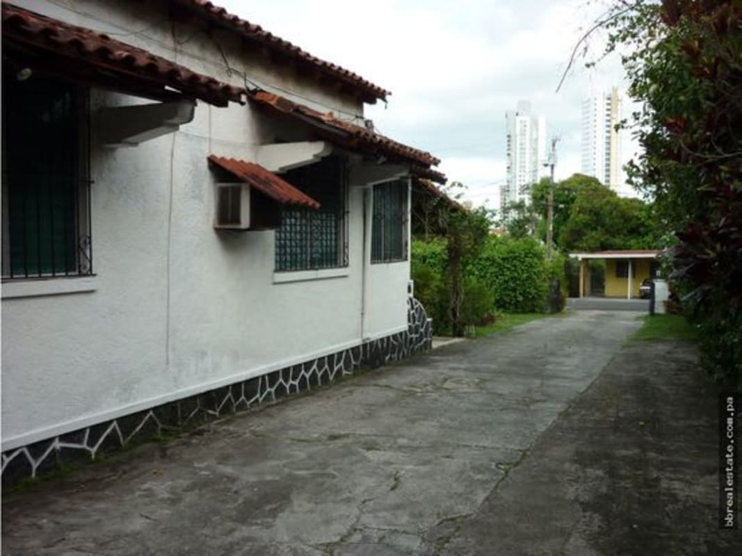 Private swimming pool surrounded by lush garden and terrace in Altos del Golf Panama