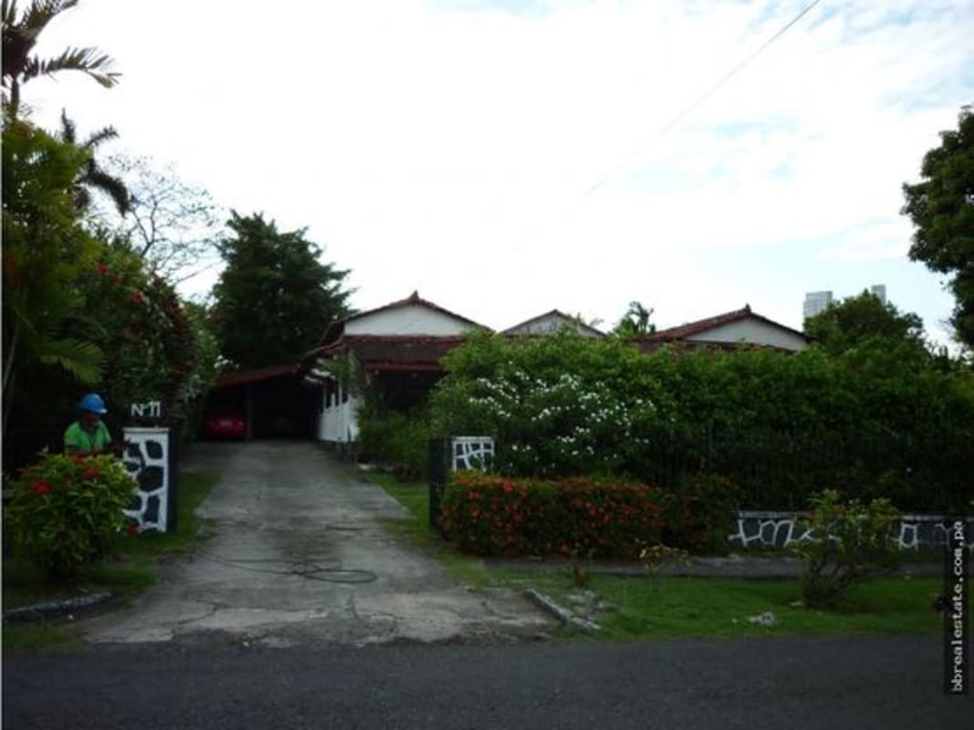 Long gated driveway lined by trees leads to luxury residence in Altos del Golf Panama