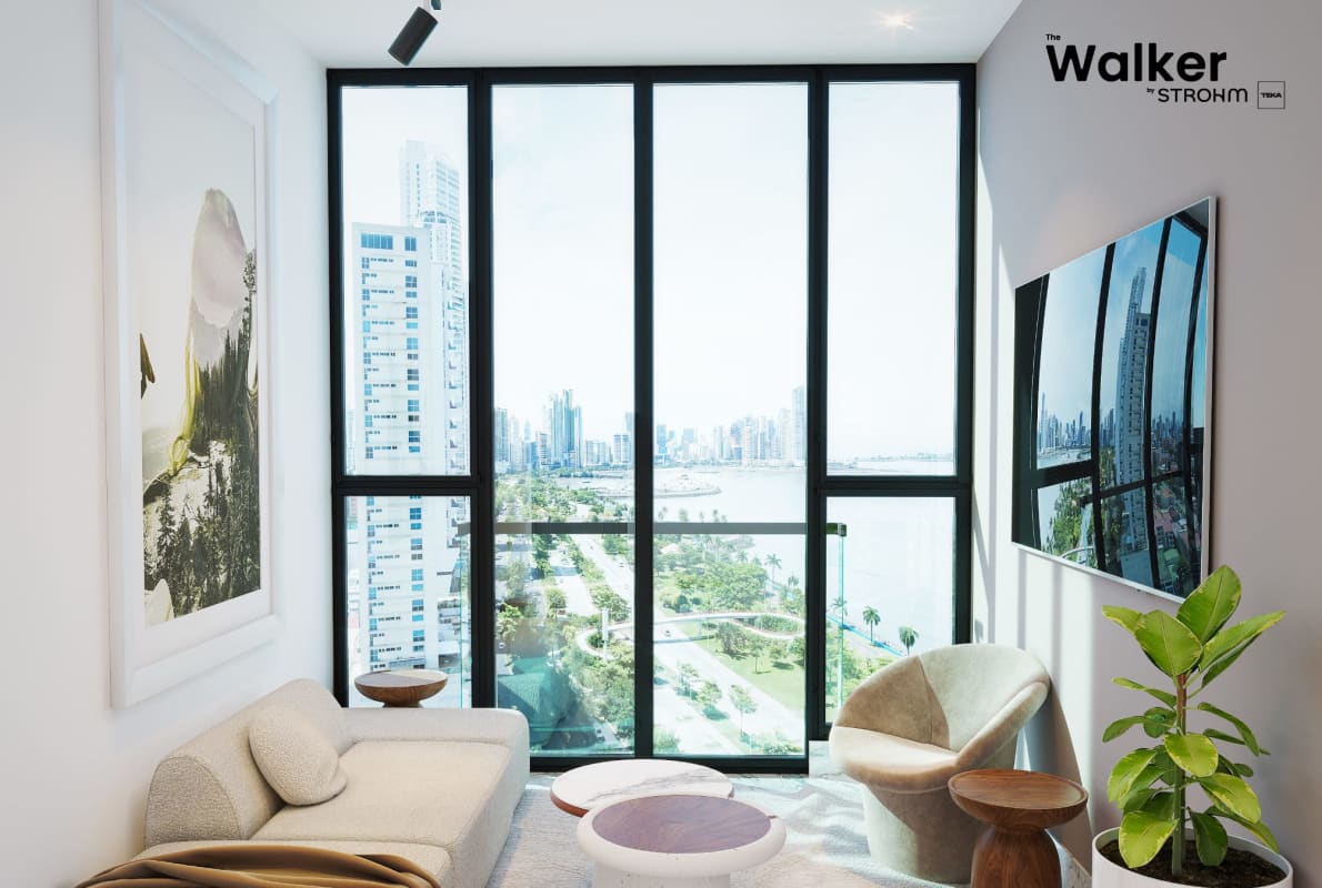 Minimalist living zone with floor-to-ceiling glass overlooking Panama skyline and waterfront
