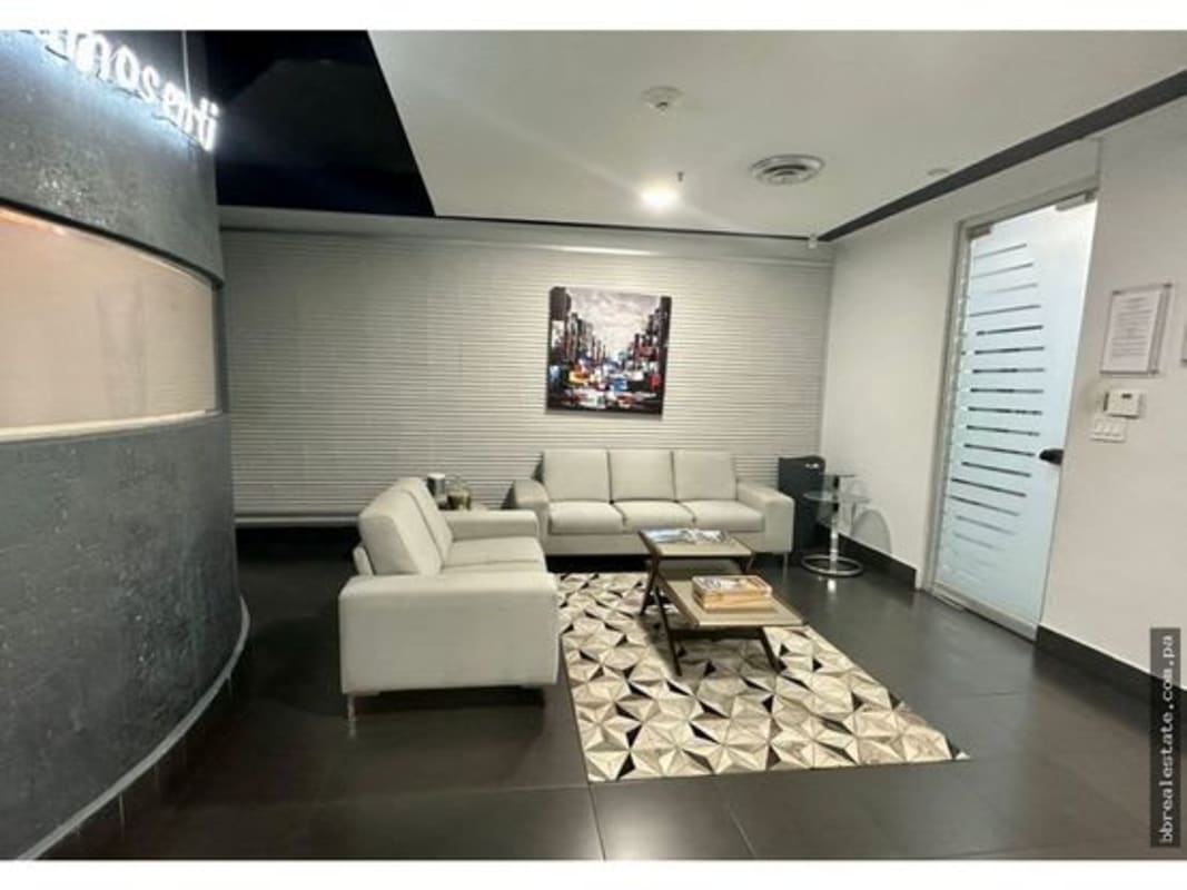 Boardroom with large table and presentation screen in modern Torre de las Américas building