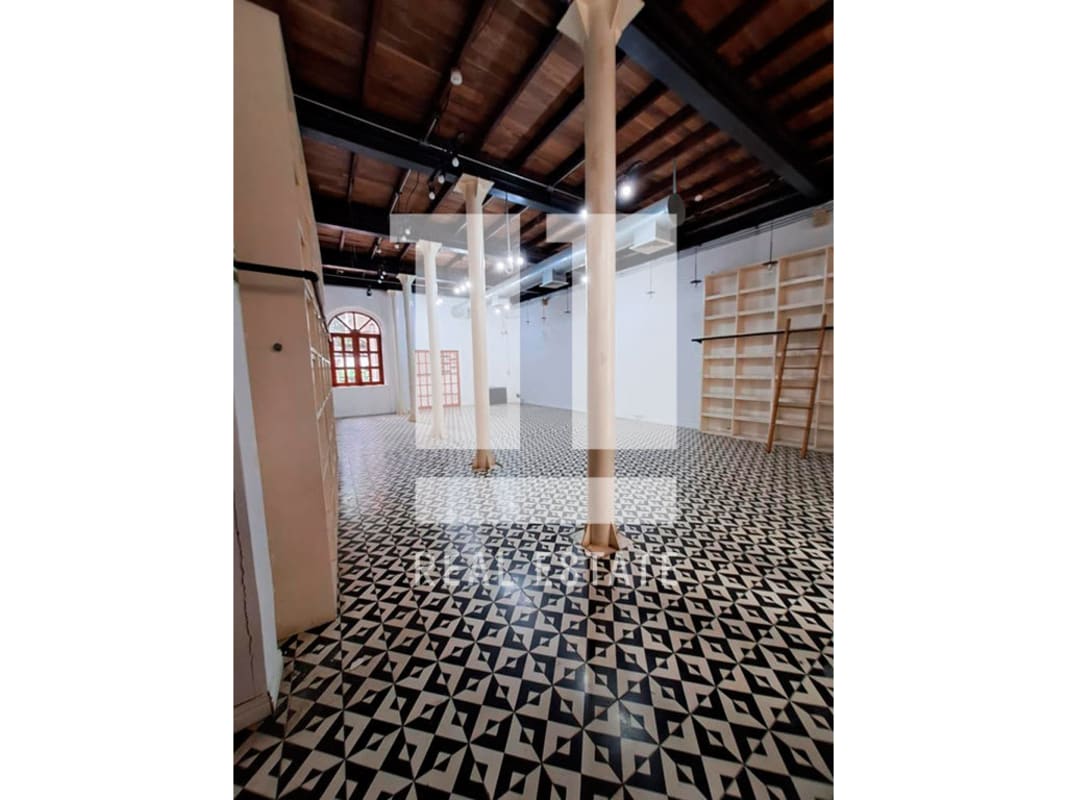 Stone walls, colorful mural, wooden staircase, mosaic floor tiles Casco Viejo Panama