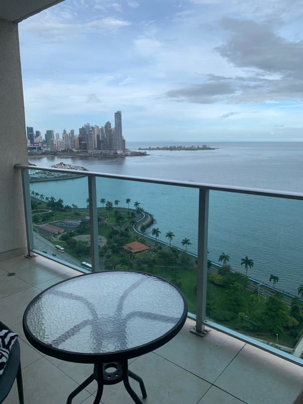 Oceanfront balcony with skyline and water views at PH H2O Avenida Balboa Panama City