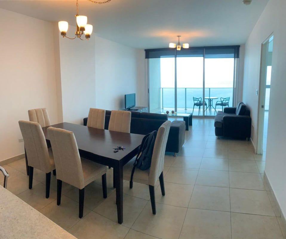 Living room with tile floors, sofas, balcony access and panoramic ocean views in PH H2O On The Ocean Panama City