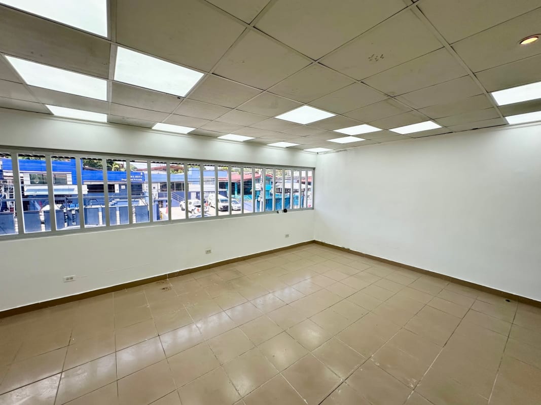 Empty tiled office space with big windows and fluorescent lighting Plaza La Bonanza Betania Panama