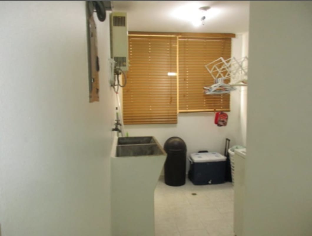 Modern kitchen featuring granite countertop, dark cabinetry, stainless appliances in PH Park Place Parque Lefevre Panama