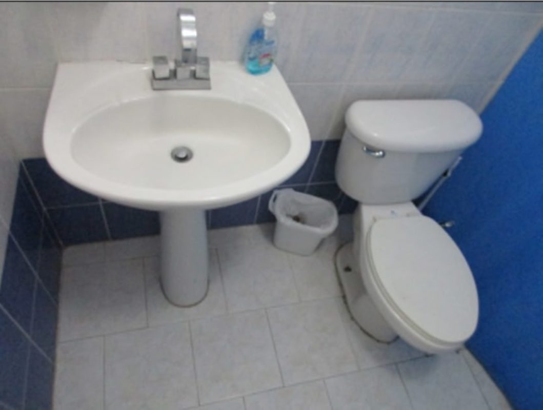 Covered swimming pool connected to hot tub surrounded by seating area at PH Park Place Parque Lefevre Panama City