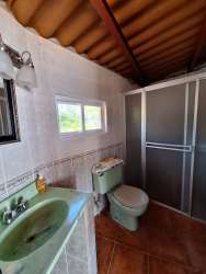 Circular blue swimming pool with poolside gazebo countryside mountain views El Jobo Las Lajas Panama