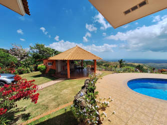 Spacious living room with tiled floor, large window, rustic decor in Sora mountain house Panama