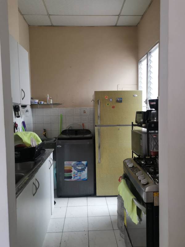 Compact kitchen with yellow fridge, gas stove, microwave shelf, washing area PH Carrasquilla Residences Panama